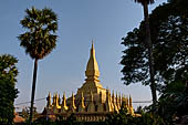 Vientiane, Laos - Surrounded by a cluster of pointed minor stupas the huge Pha That Luang shined under the warm light of the sunset.  